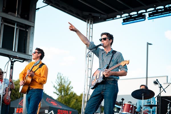 A band performing on an outdoor stage