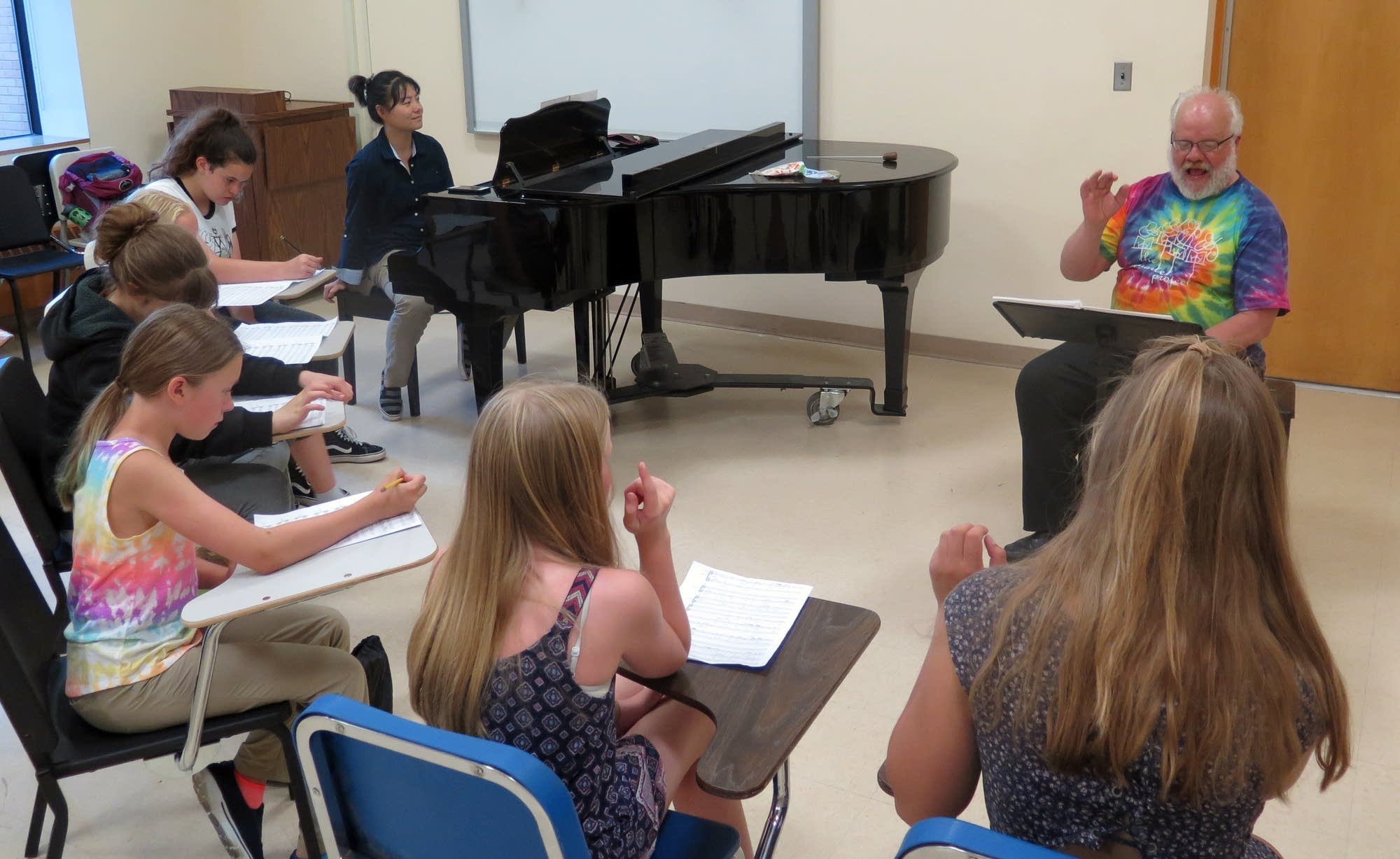 Director Warren Friesen, composer Wang Jie rehearse children's chorus.