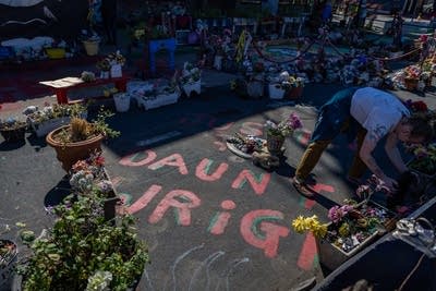 A person cleans a memorial