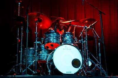 A musician plays drums onstage