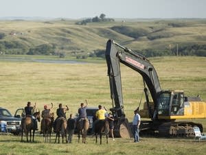 Tribal warriors face pipeline security.