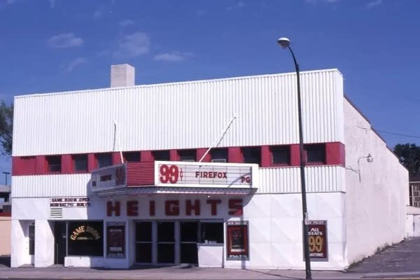 Vintage photo of a white movie theater with red and black accents.