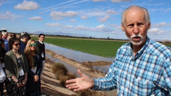 David DeJong speaks to a tour group on the Gila River Indian Community reservation in Arizona. Corporations helped fund a new irrigation system for GRIC's alfalfa fields.