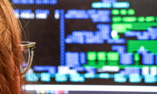 A woman looks at her computer