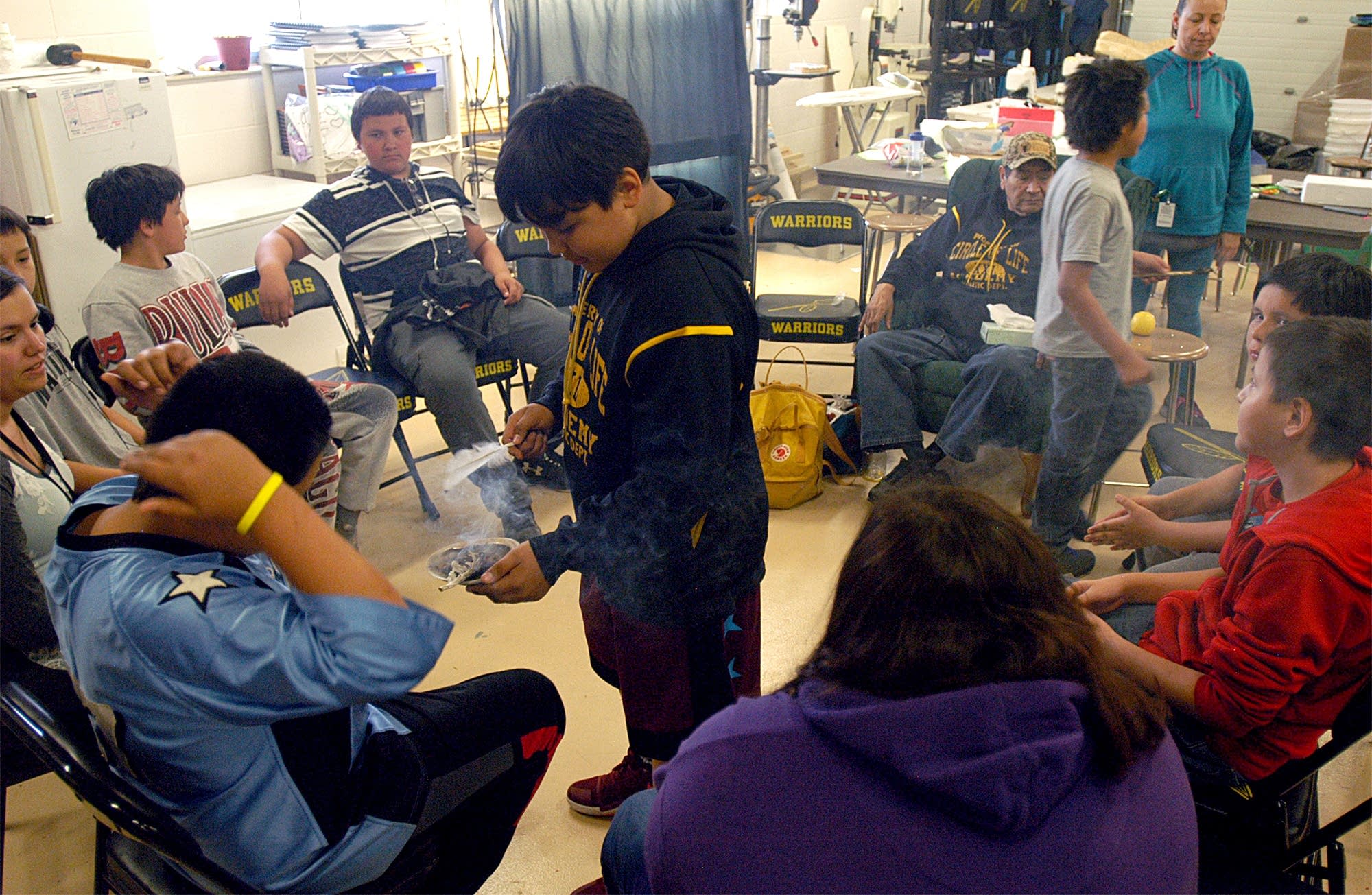 Ken Fox III offers the smudge for cleansing during culture class.