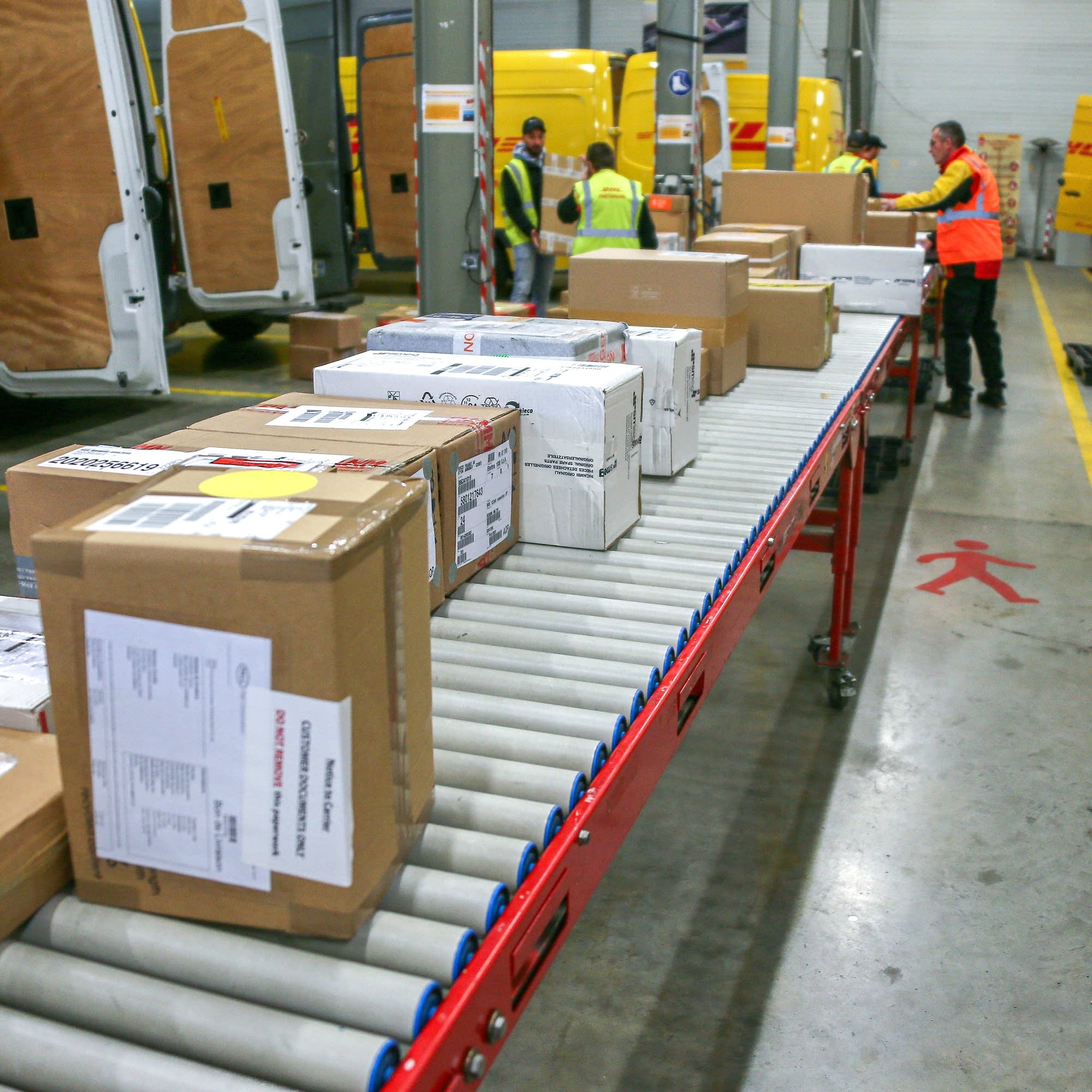 Boxed parcels moving through a warehouse dispatch area
