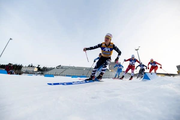 Skiers turn a corner in a race.