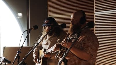 Two musicians performing in a recording studio