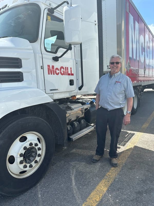 Steve Austin in front of a semi truck.