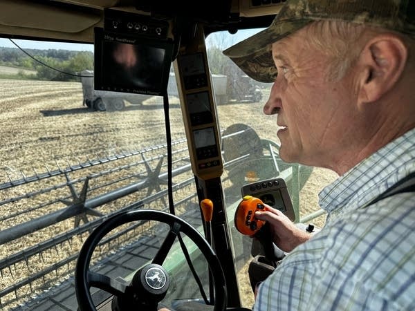 Close-up of a man in the driver's seat of a combine.