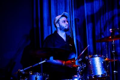 A musician plays drums onstage