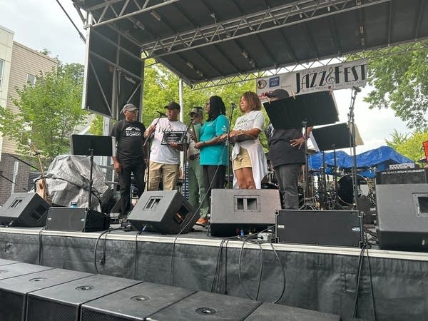 A small group gathers on a stage.