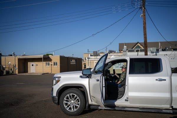A woman sits in a large pickup truck.