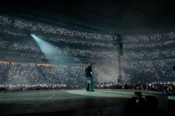 Kendrick Lamar on stage with stadium crowd in front