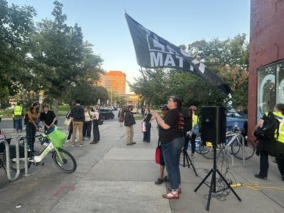 A person raises a flag