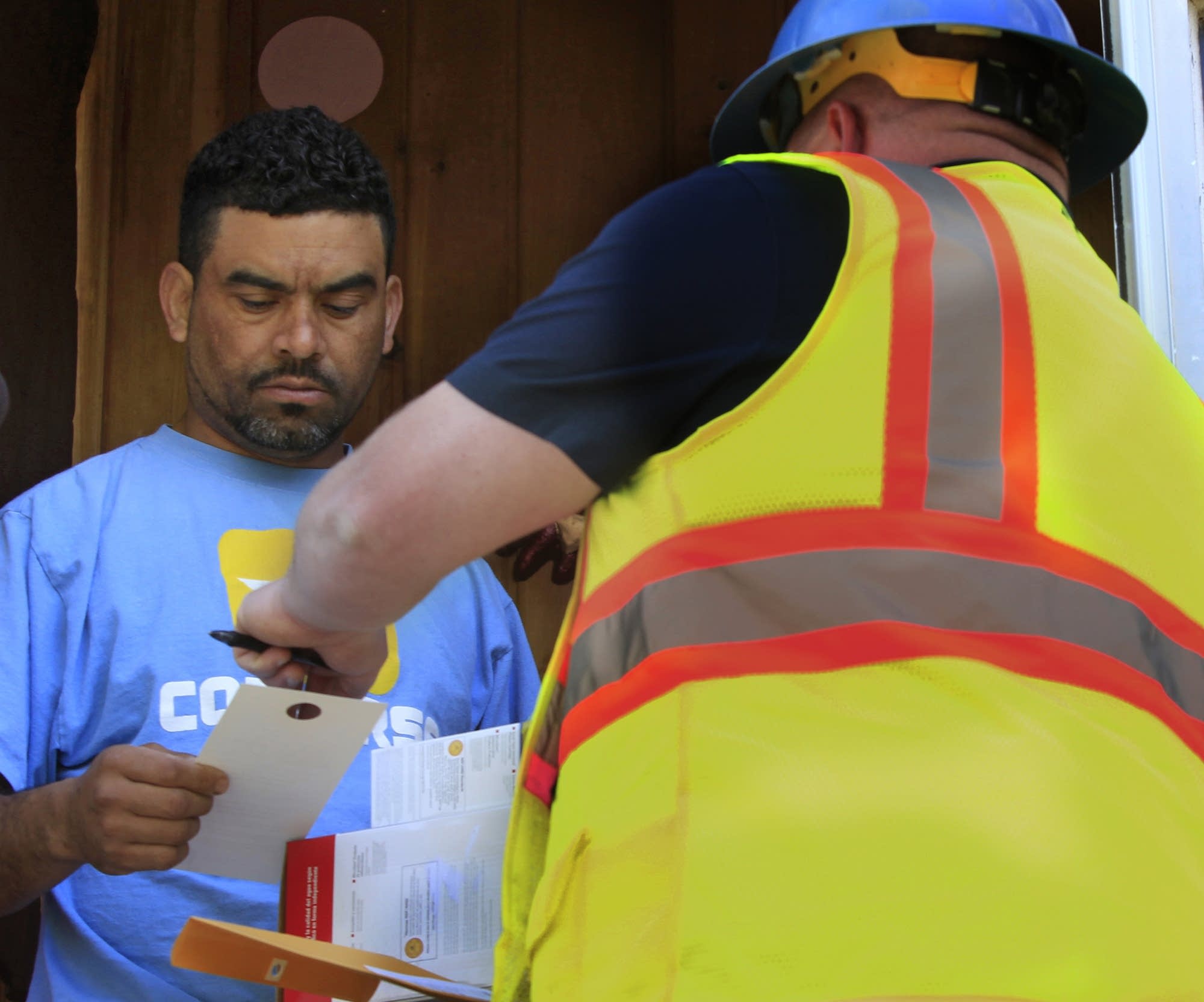 Homeowner Ronald Mendoza listens to instructions.