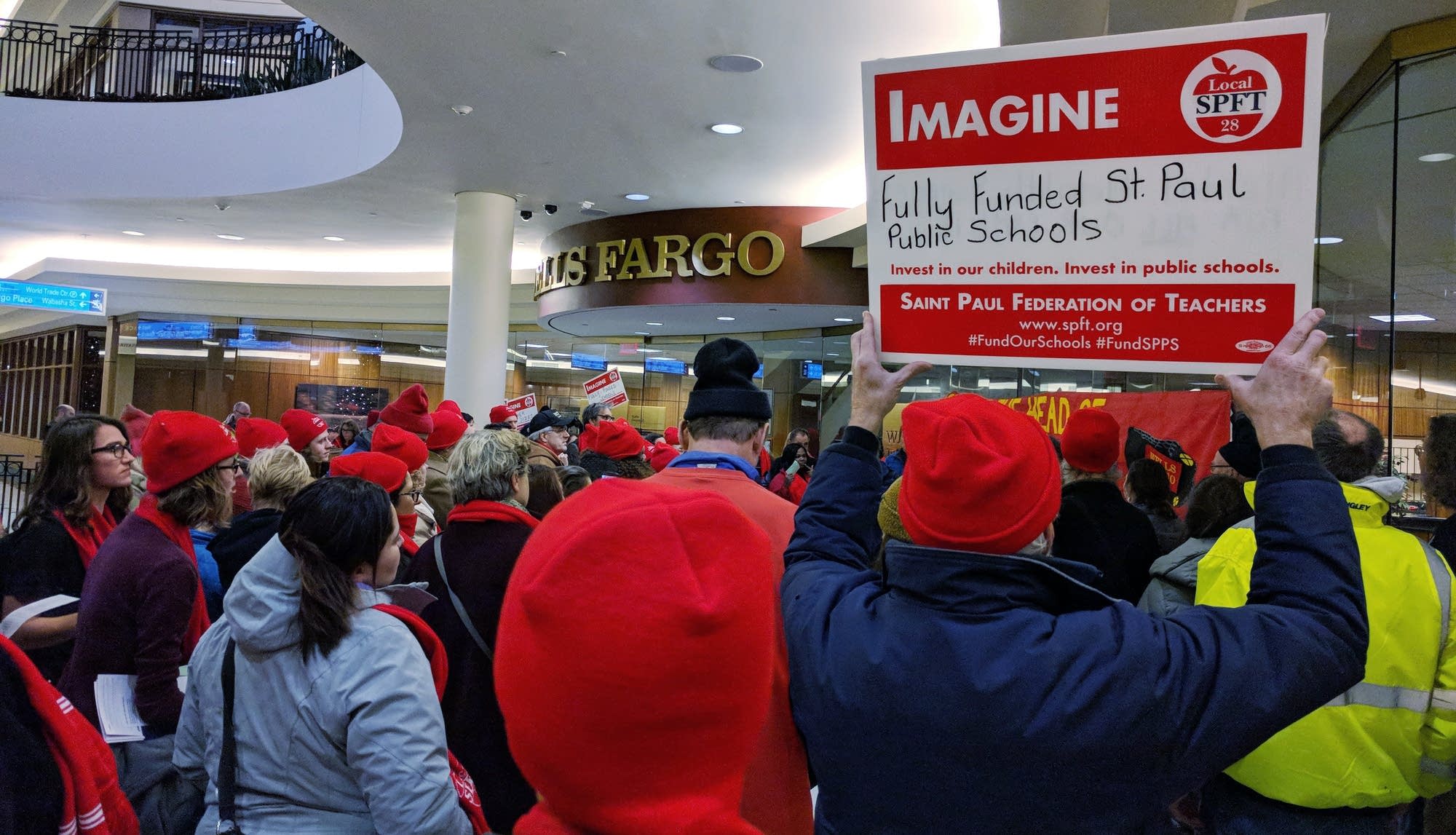 Members of the St. Paul teachers union protest outside Wells Fargo.