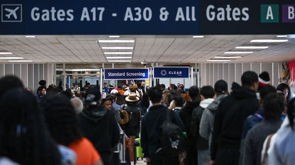 Travelers at Houston's George Bush Intercontinental Airport on Friday.