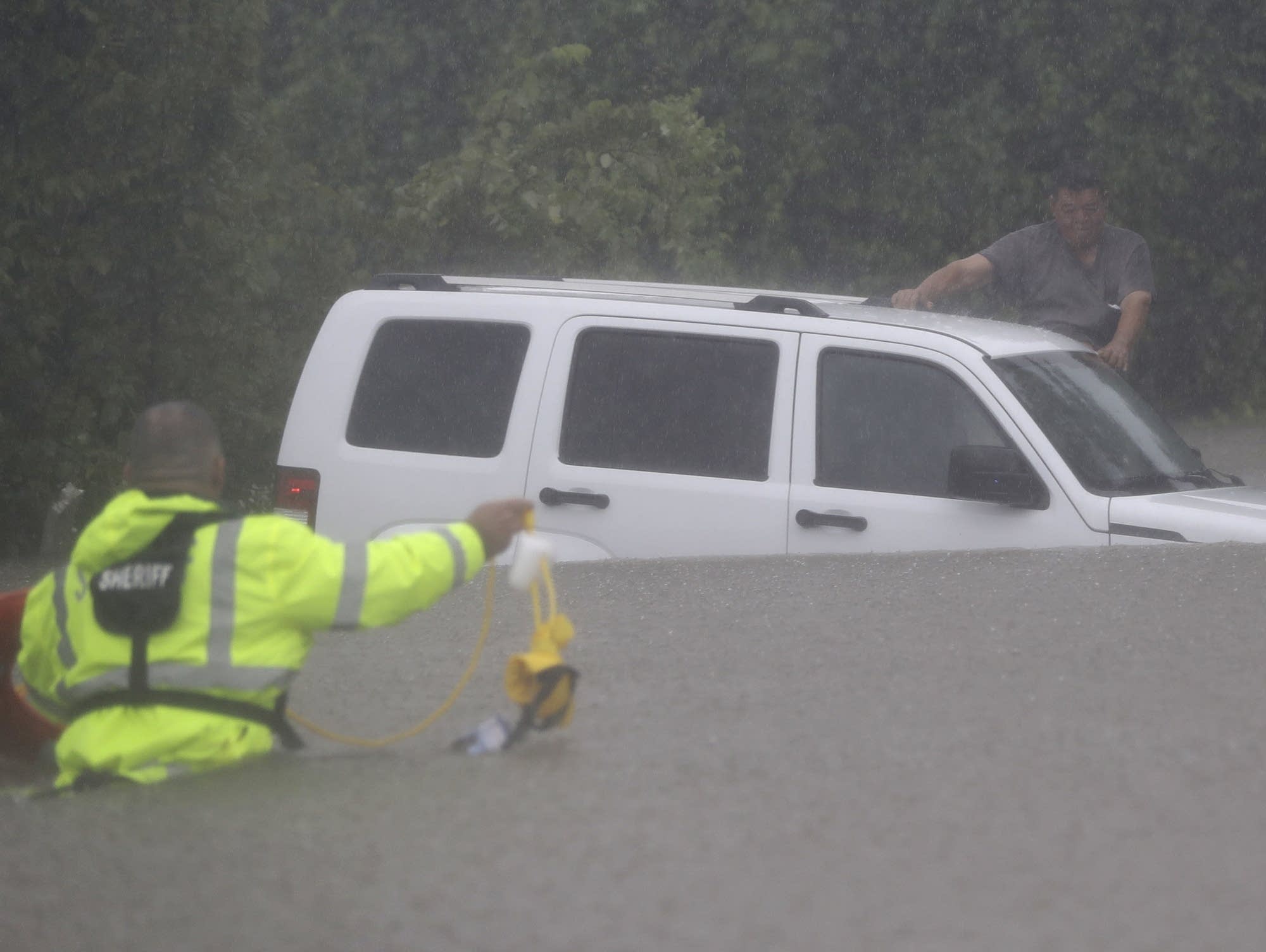 A man waits to be rescued by the Harris County Sheriff's Department