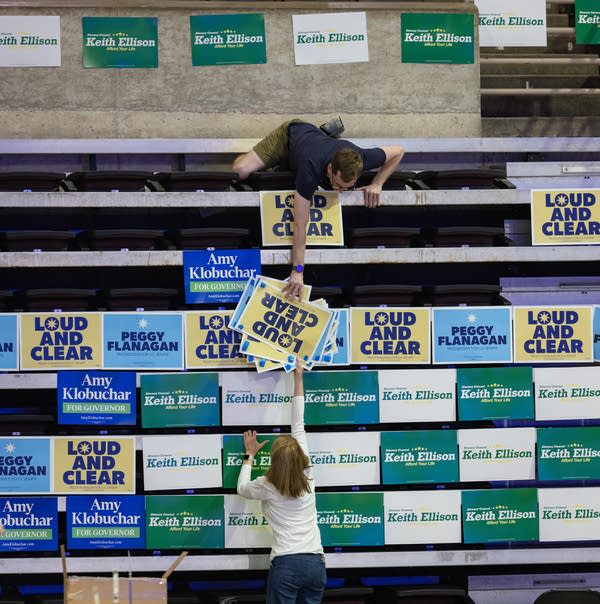 Volunteers posting candidate signs