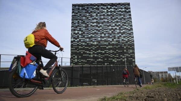 A woman rides past Nexperia headquarters in Nijmegen, the Netherlands, on Nov. 6.