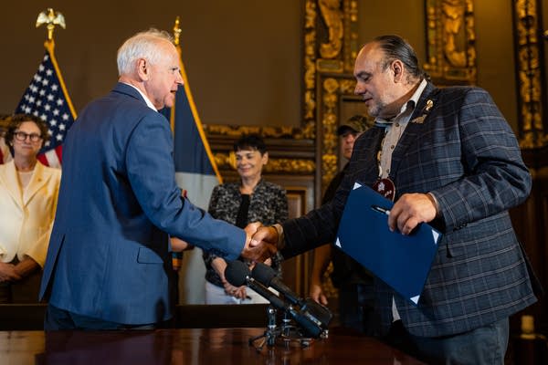 two people shake hands