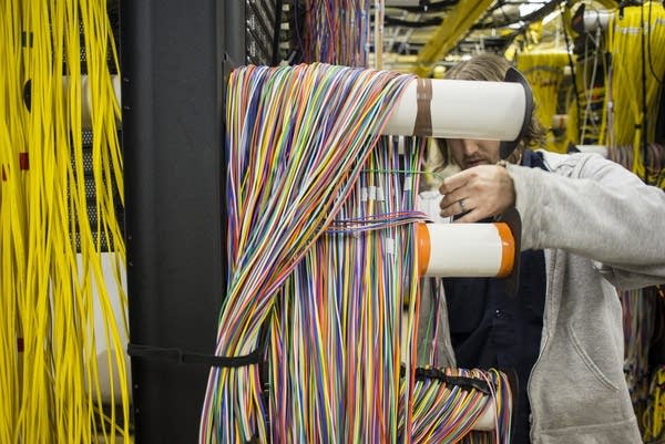 US Internet employee separates fiber optic cables.