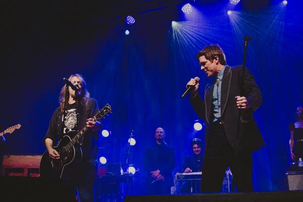 Two musicians performing together onstage