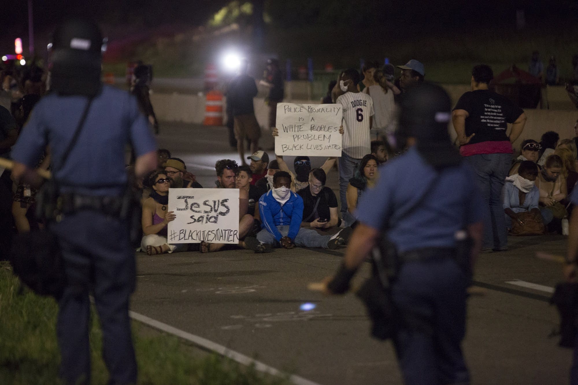 Protesters stand and sit on I-94.