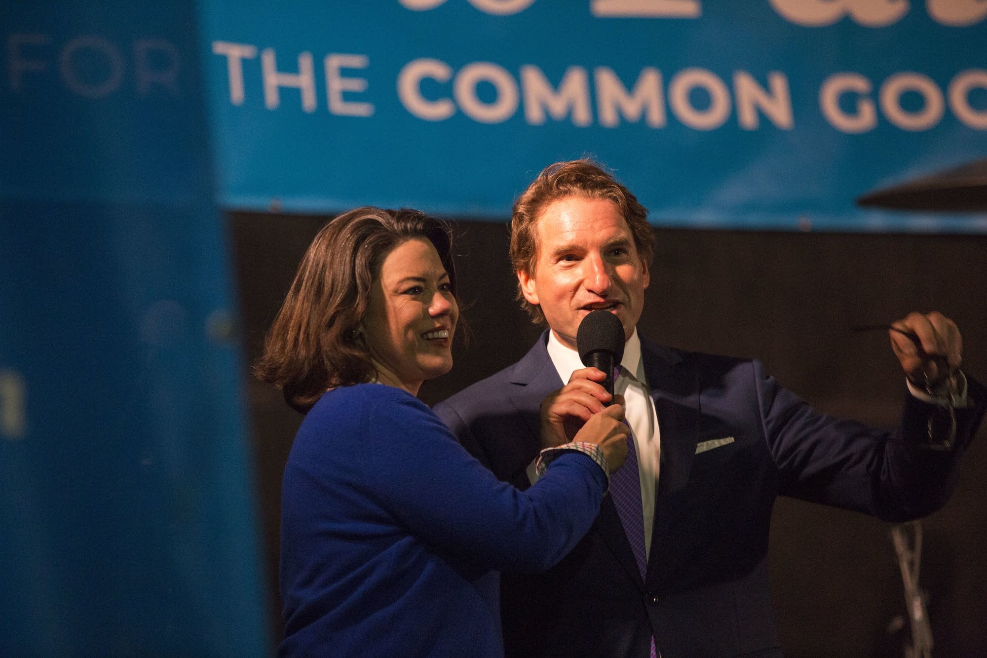 DFL Candidates Angie Craig and Dean Phillips share a moment on stage