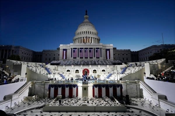 The US Capitol and stage are lit as the Sun begins to rise before events get underway before the 59th Presidential Inauguration at the US Capitol in Washington, DC on January 20, 2021. 