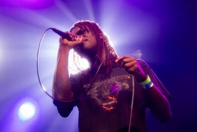 Papa Mbye sings into a microphone.