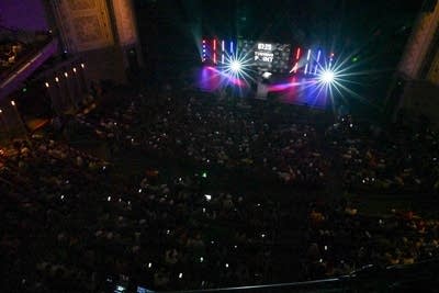 People sit and listen to someone on a stage