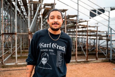 Dijon posing for a portrait next to bleachers
