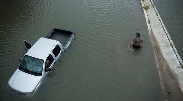 

A truck driver walks past an abandoned truck while checking the depth of an underpass during the aftermath of Hurricane Harvey Aug. 28, 2017 in Houston, Texas.








