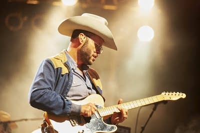 charley crockett performing on an outdoor stage at night
