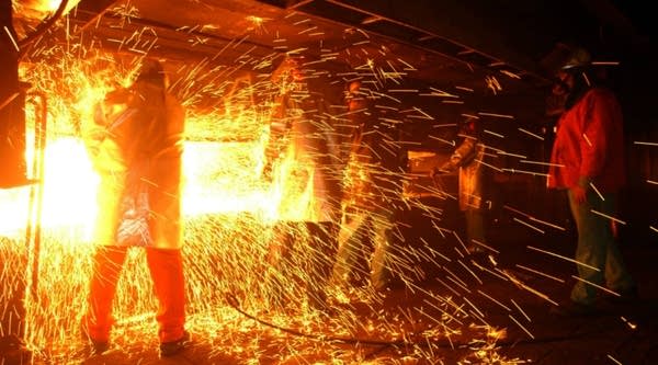 Casters are showered with sparks, or 'skeeters,' as molten steel is shaped into bars called 'billets' at the TAMCO steel mini mill on October 4, 2002 in Rancho Cucamonga, California. 