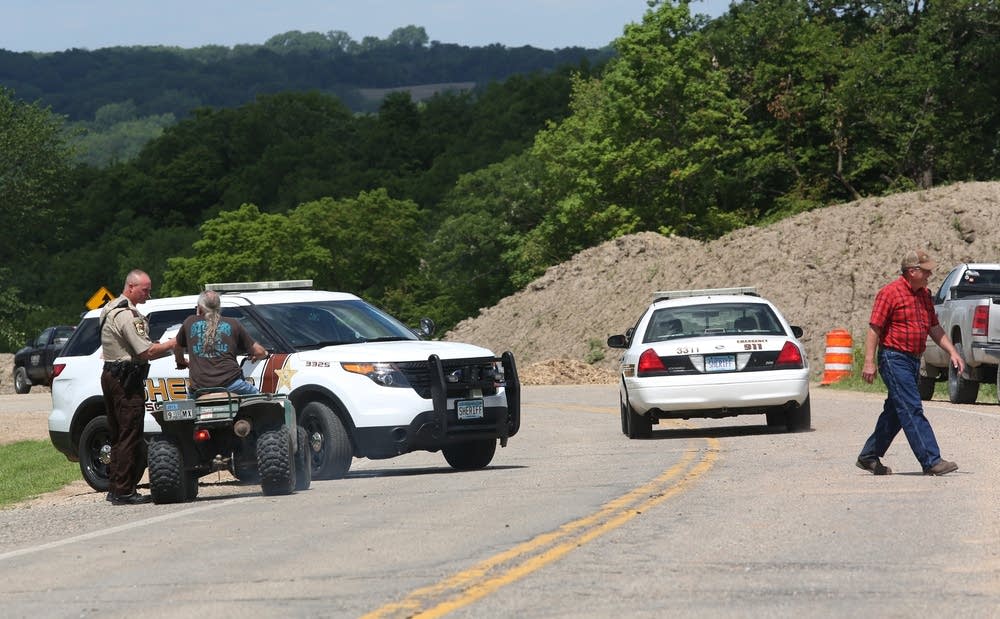 Police officers block the road to Blakeley