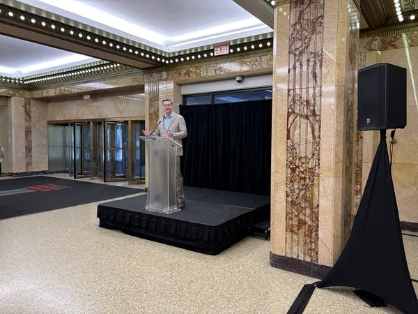 A man stands behind a podium.