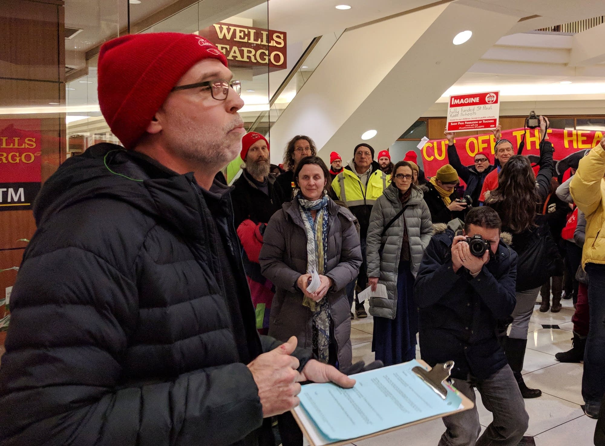 St. Paul Fed. of Teachers president Nick Faber speaks outside Wells Fargo.