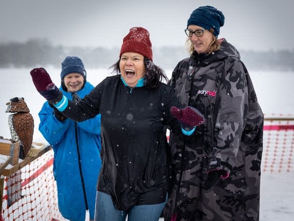 A person smiles after ice hole dipping