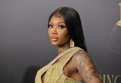 A woman in formal attire arrives at an awards event