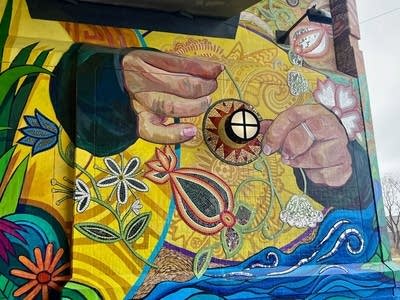 A view of a mural under a bridge.