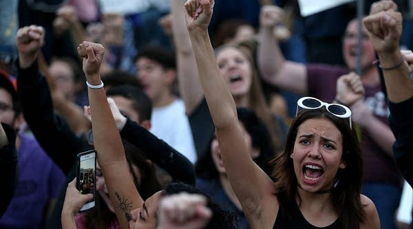 Protesters chant as they block a road during a demonstration against the immigration ban imposed by President Donald Trump.