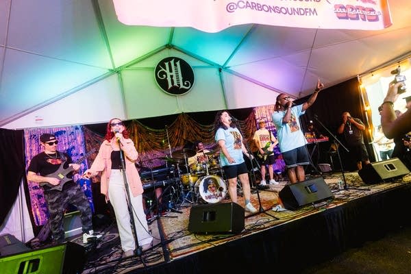 illism and their band performing on stage