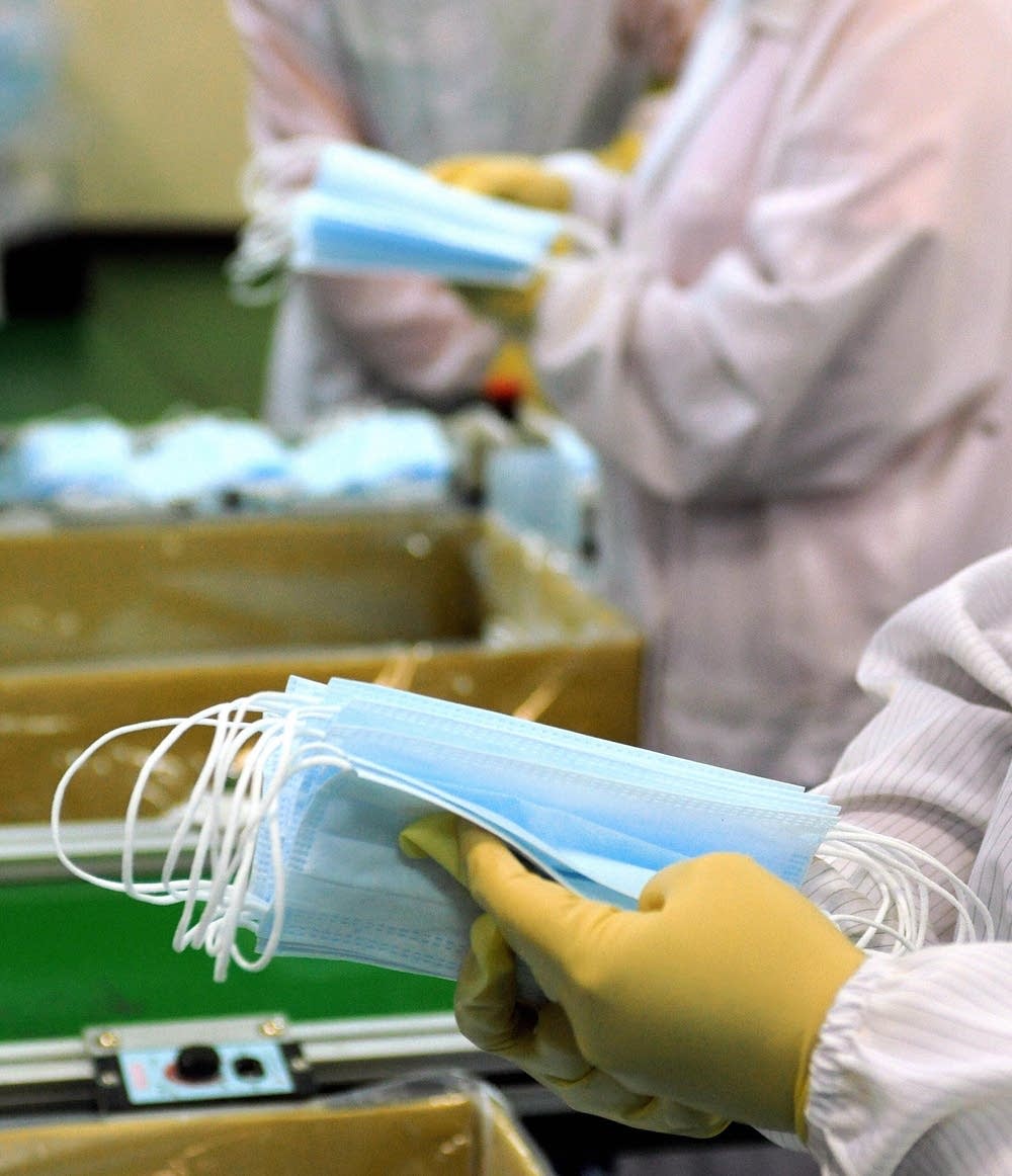 Workers sort out face masks