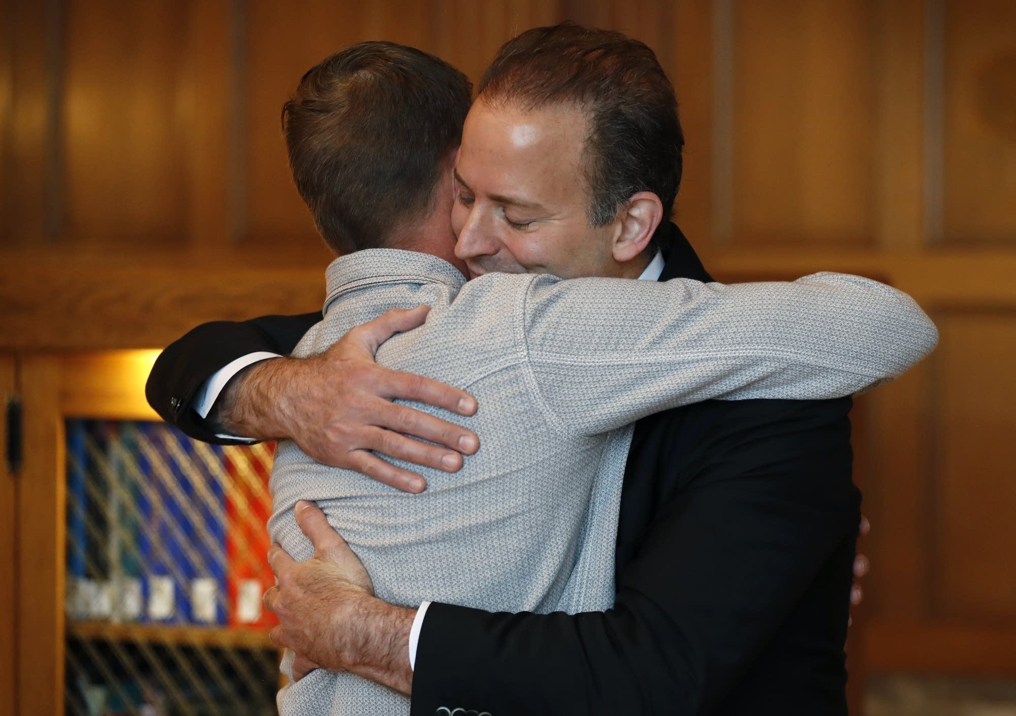 Andy Sandness, left, gets a hug from Dr. Samir Mardini.