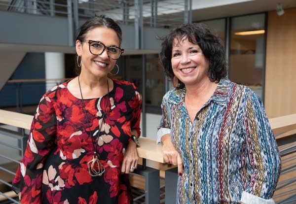 two women smiling for a portrait