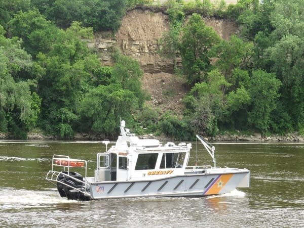 A boat from the Hennepin County Sheriff's Office passes near the mudslide.