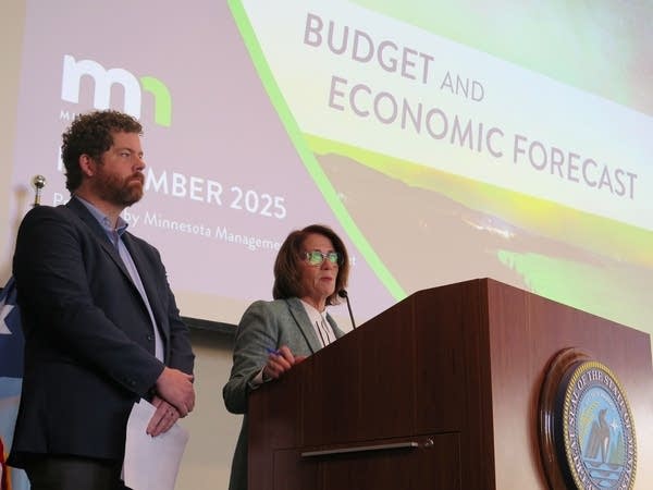 People speak at a podium